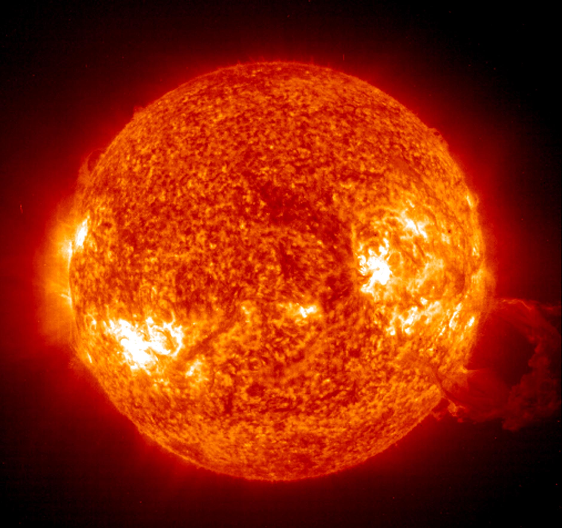 This 26 October, 2003 NASA Solar and Heliospheric Observatory image shows a giant magnetic loop (R) filled with glowing-hot gas blasting away from the Sun. Two Jupiter size sunspots are crossing the face of the Sun at the same time and pose threats for X-class solar flares, major events that can trigger planet-wide radio blackouts and long-lasting radiation storms. AFP PHOTO/NASA